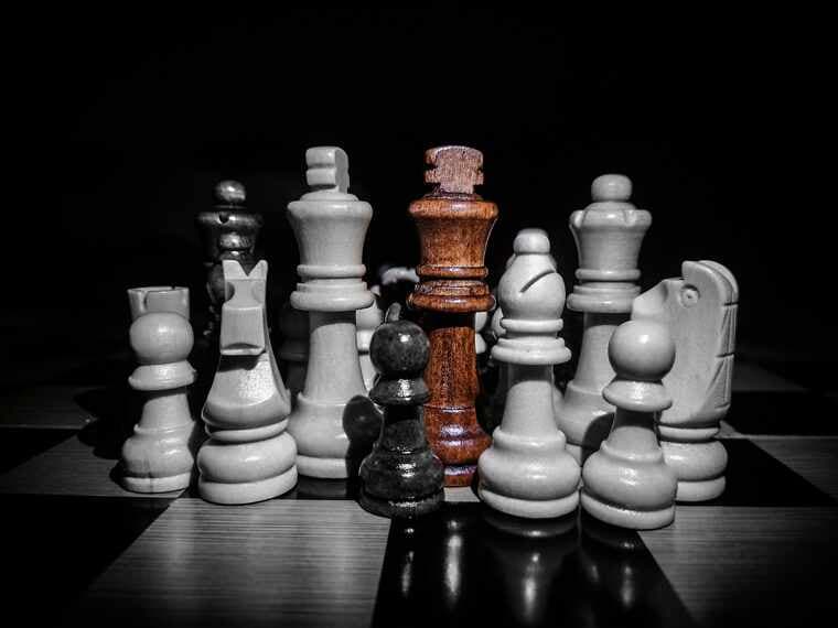 Chess pieces facing each other across a board