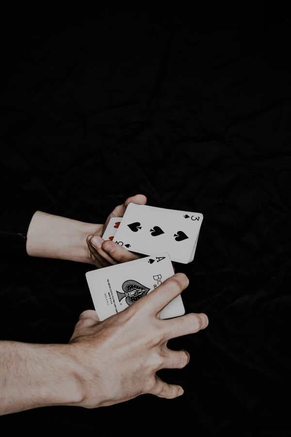 A hand holding playing cards