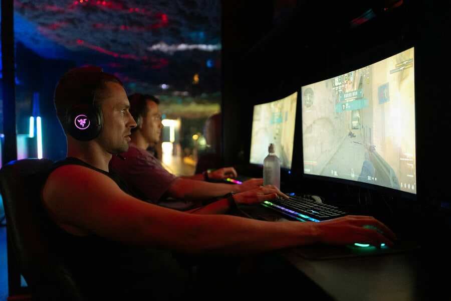 Esports players competing at desktop computers