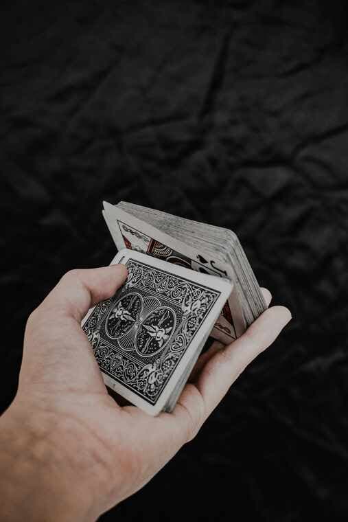 A hand holding playing cards